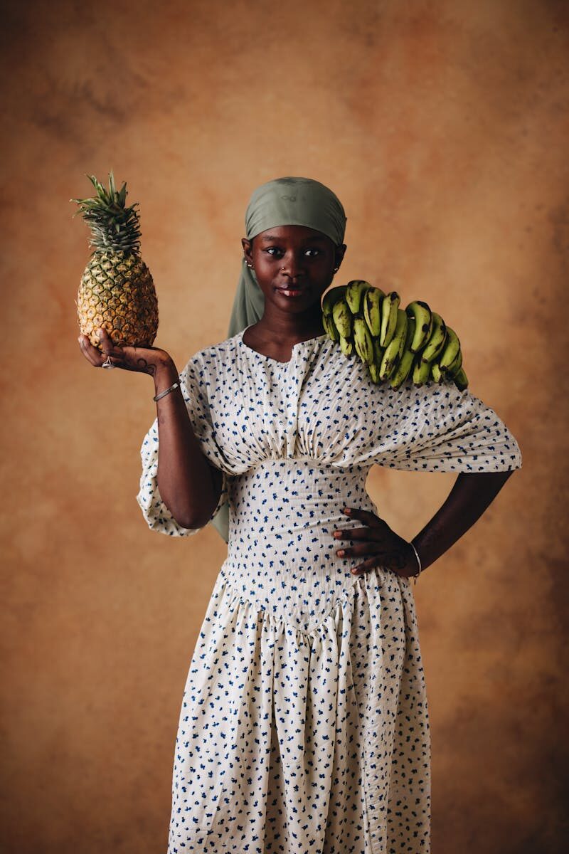 Elegant portrait of a woman in traditional attire with fruit.